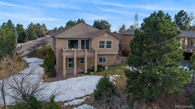 rear view of property with a balcony