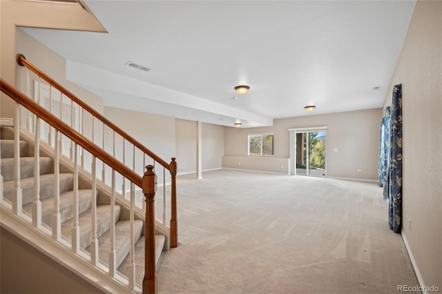 basement featuring light colored carpet