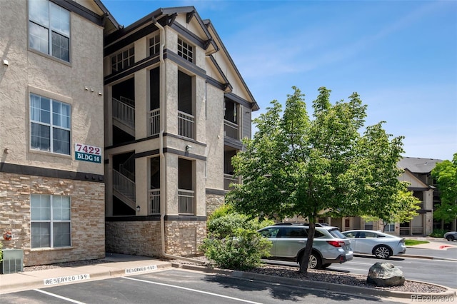 7422 S Quail Cir Unit 1624, Littleton, CO 80127 - view of property featuring uncovered parking and central AC unit