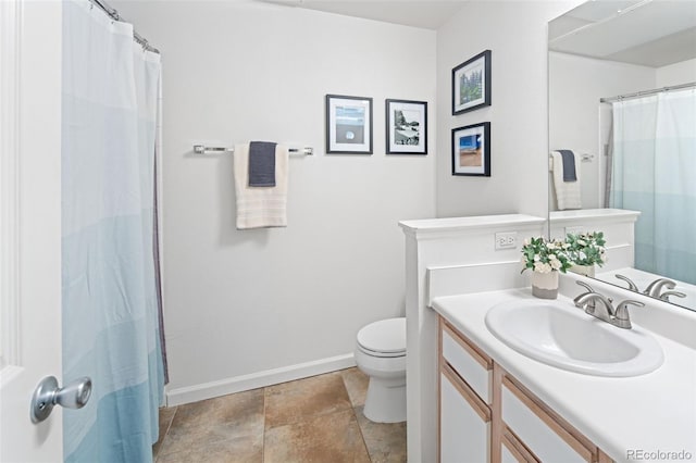 7422 S Quail Cir Unit 1624, Littleton, CO 80127 - bathroom featuring toilet, vanity, and baseboards