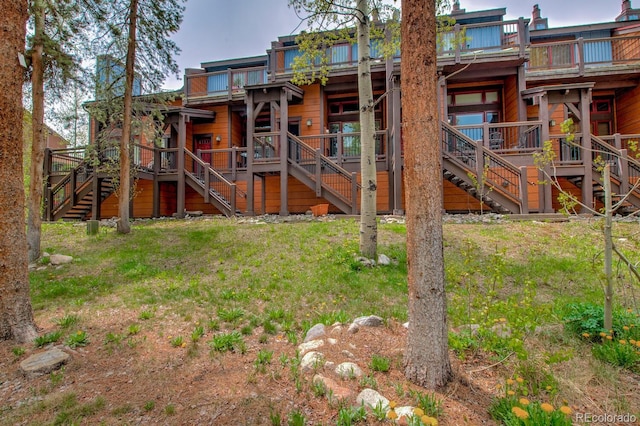 200 Primrose Path Unit 11, Breckenridge, CO 80424 - rear view of house featuring stairs, a lawn, and a deck