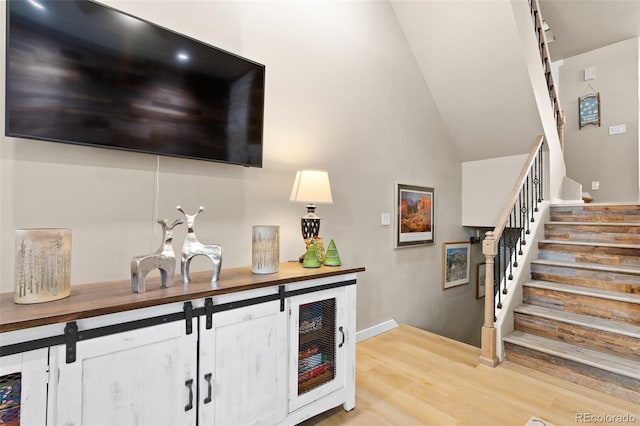 200 Primrose Path Unit 11, Breckenridge, CO 80424 - bar featuring stairs, wood finished floors, a towering ceiling, and baseboards