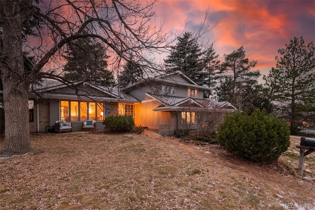 view of back house at dusk