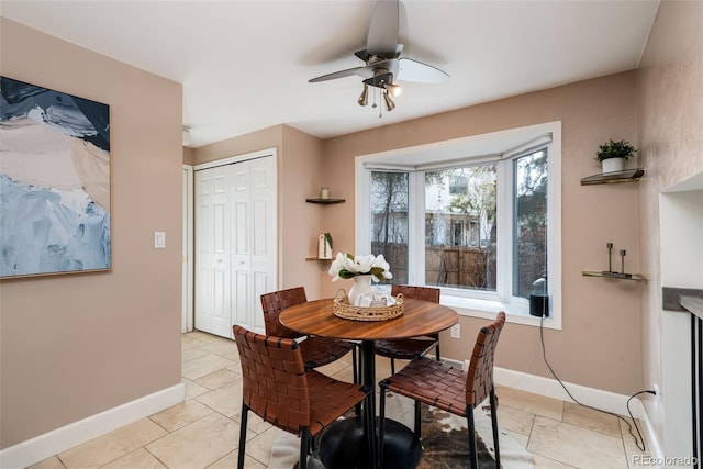 tiled dining space with ceiling fan