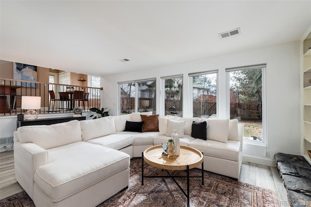 living room with a healthy amount of sunlight and hardwood / wood-style flooring