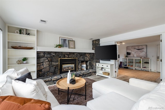 living room with a fireplace and hardwood / wood-style floors