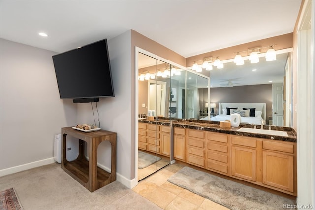 bathroom with ceiling fan, tile patterned floors, and vanity