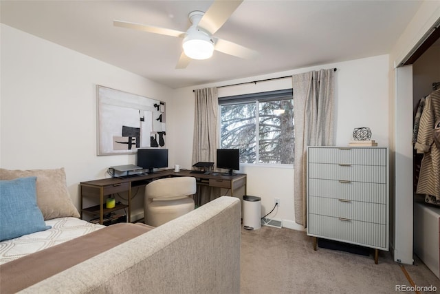 bedroom featuring ceiling fan, a closet, and light colored carpet