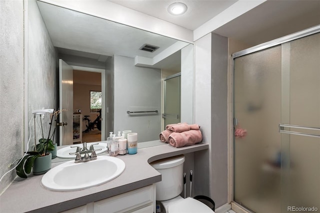 bathroom with toilet, walk in shower, and vanity