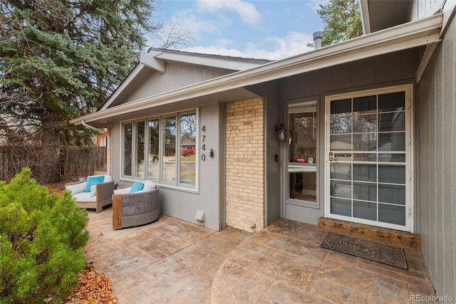 doorway to property with an outdoor living space and a patio