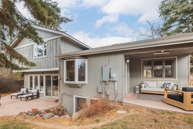 back of property featuring a patio area and an outdoor living space