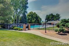 view of community featuring a lawn and a swimming pool