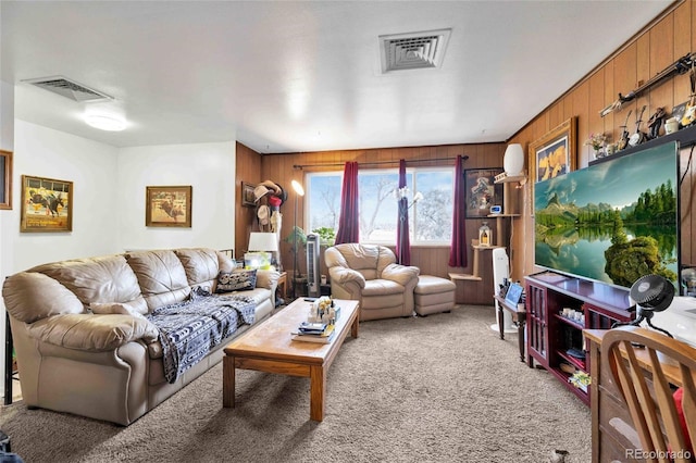 living room with carpet flooring and wood walls