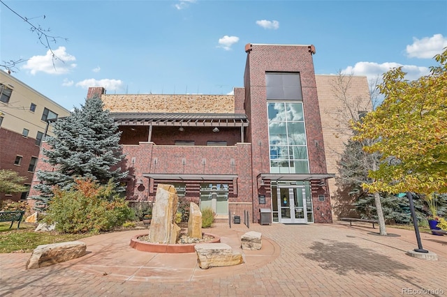 3601 Arapahoe Ave Unit 226, Boulder, CO 80303 - rear view of house featuring french doors, brick siding, and a balcony
