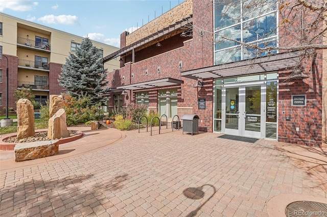 view of patio with a balcony and french doors