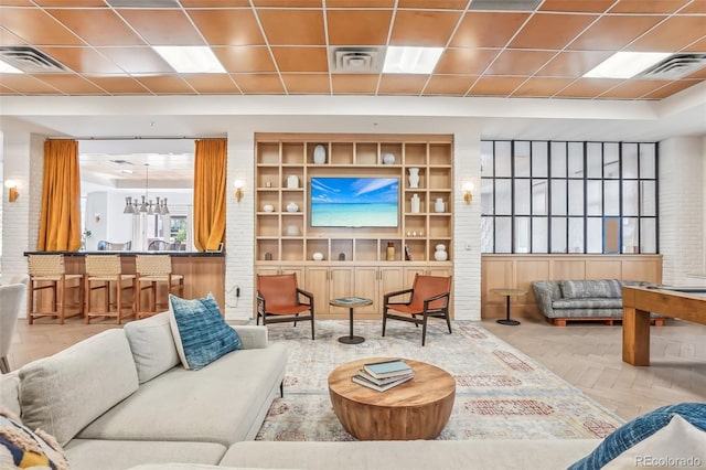 living room with an inviting chandelier and parquet floors