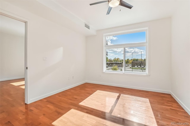 empty room featuring ceiling fan and hardwood / wood-style flooring