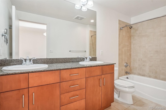 full bathroom with vanity, toilet, tiled shower / bath combo, and tile patterned flooring