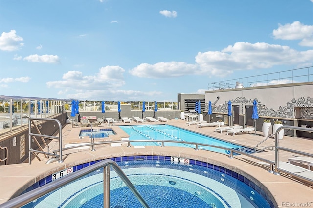 view of swimming pool with a community hot tub and a patio area