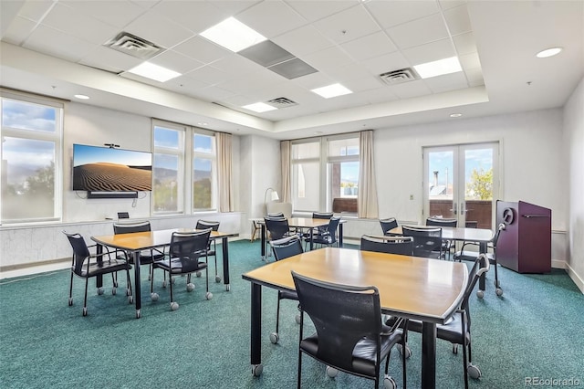 carpeted dining room featuring a drop ceiling, a tray ceiling, and french doors