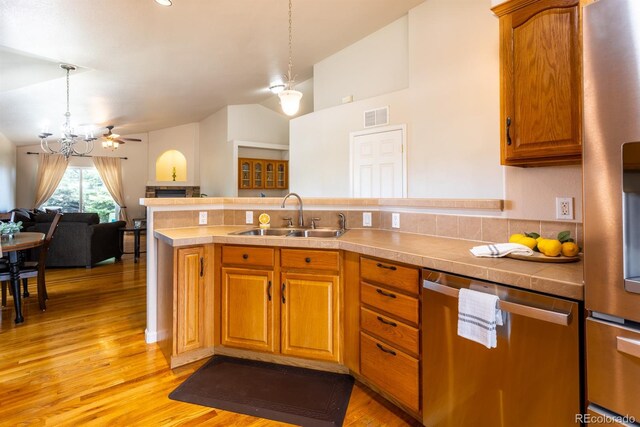 kitchen featuring sink, ceiling fan, light wood-type flooring, and stainless steel appliances