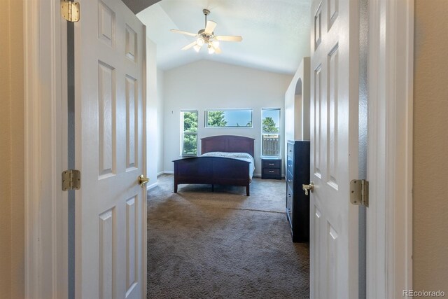 bedroom with dark carpet, ceiling fan, and lofted ceiling