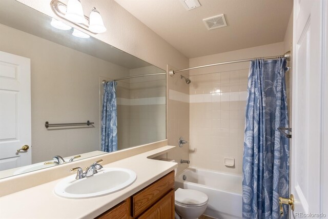 full bathroom featuring toilet, vanity, and shower / tub combo with curtain