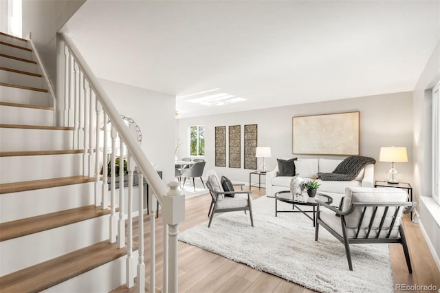 living area featuring wood finished floors and stairs