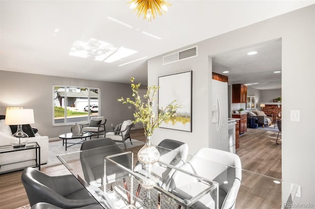 dining space with recessed lighting, baseboards, and light wood-style floors