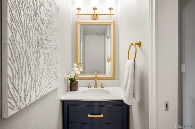 bathroom featuring vanity and a textured wall