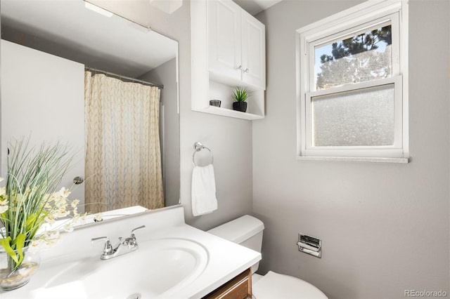 bathroom with vanity, toilet, and a shower with curtain