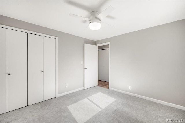 unfurnished bedroom featuring carpet flooring, baseboards, and ceiling fan