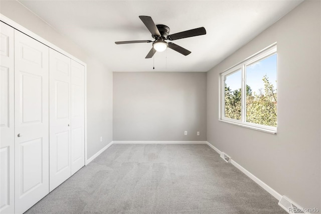 unfurnished bedroom with carpet flooring, a closet, and baseboards