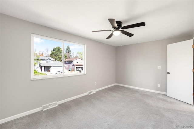 spare room with ceiling fan, carpet floors, and baseboards