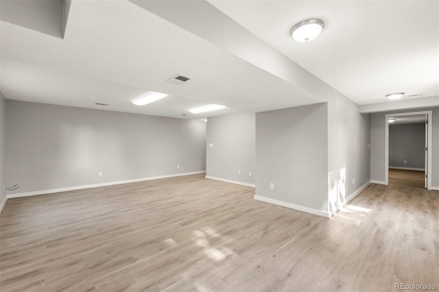 empty room featuring light wood-style floors and baseboards