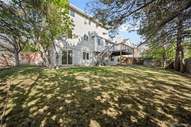 rear view of house featuring stairs and a deck