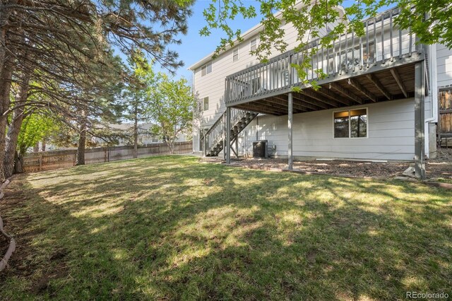 rear view of property with a wooden deck, stairway, and cooling unit