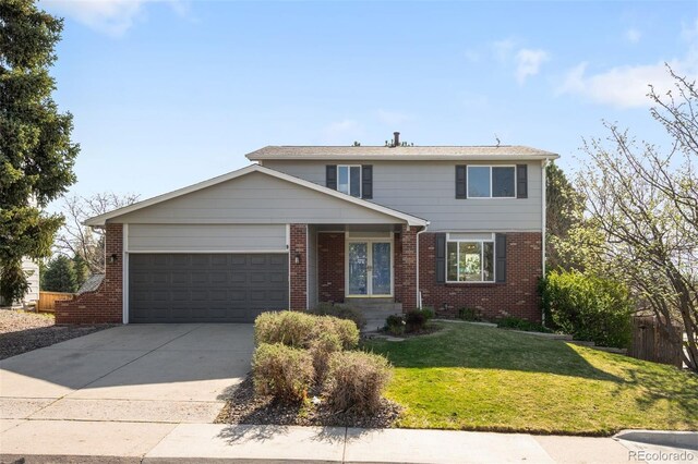 traditional-style house featuring a garage, concrete driveway, and brick siding