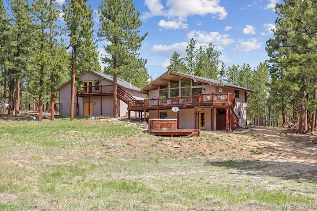 back of house featuring a deck and stairs