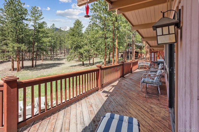 wooden terrace with a lawn