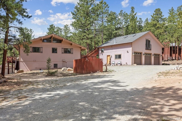 view of side of home with a detached garage