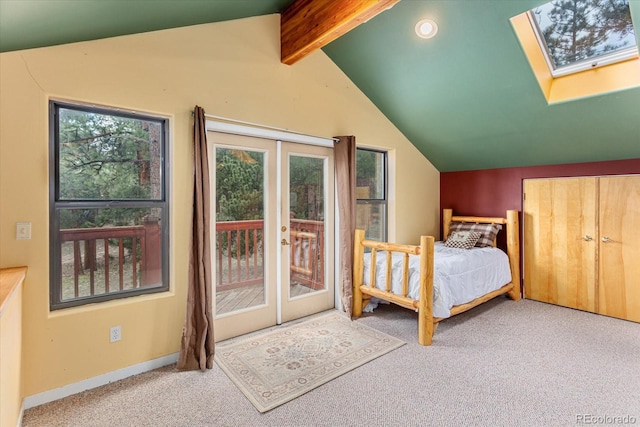 carpeted bedroom with lofted ceiling with skylight, access to outside, baseboards, and multiple windows
