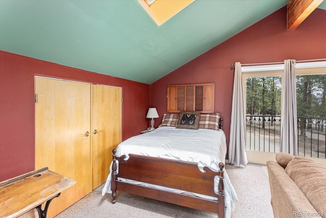 bedroom with lofted ceiling with skylight, access to outside, and carpet