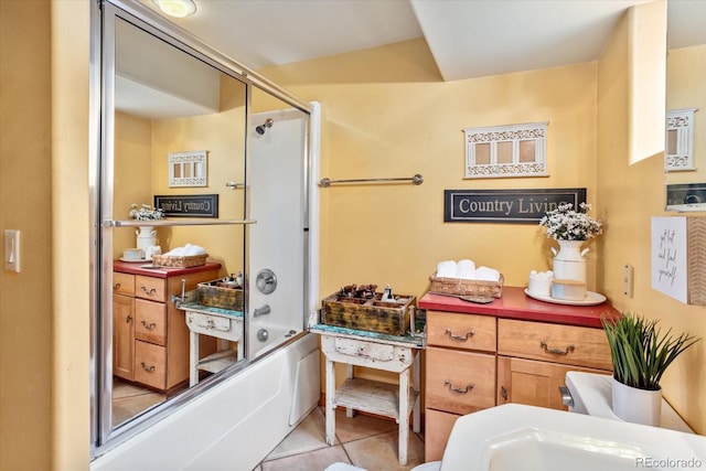 bathroom featuring combined bath / shower with glass door and tile patterned floors