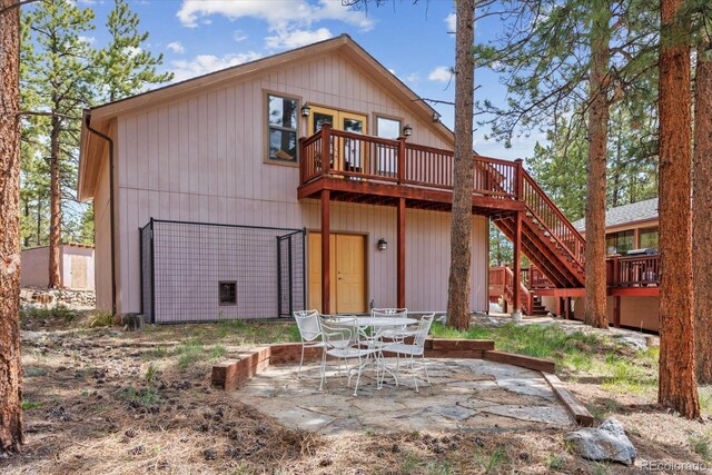 back of property featuring a patio area, stairway, and a wooden deck