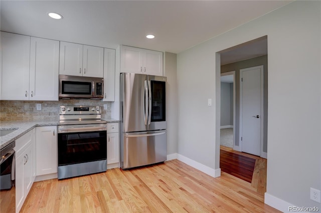 5925 W 86th Ave, Arvada, CO 80003 - kitchen with stainless steel appliances, white cabinets, decorative backsplash, and recessed lighting