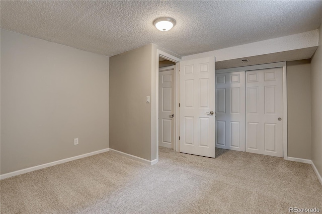 5925 W 86th Ave, Arvada, CO 80003 - unfurnished bedroom featuring light colored carpet, a textured ceiling, and a closet