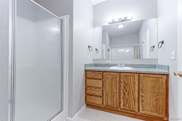 bathroom with vanity and a shower with shower door