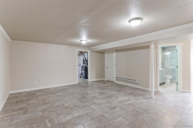 basement featuring ornamental molding, a textured ceiling, and a baseboard radiator