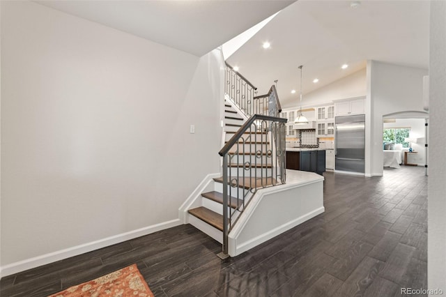 5980 Dunraven Ct, Golden, CO 80403 - staircase with wood finished floors, arched walkways, recessed lighting, and high vaulted ceiling